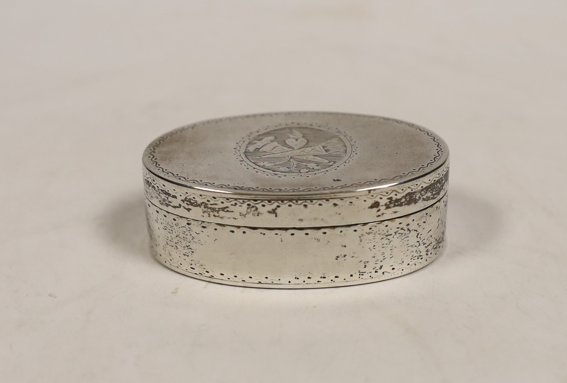 An early 19th century French engraved 800 standard white metal oval snuff box/vesta case, 69mm.